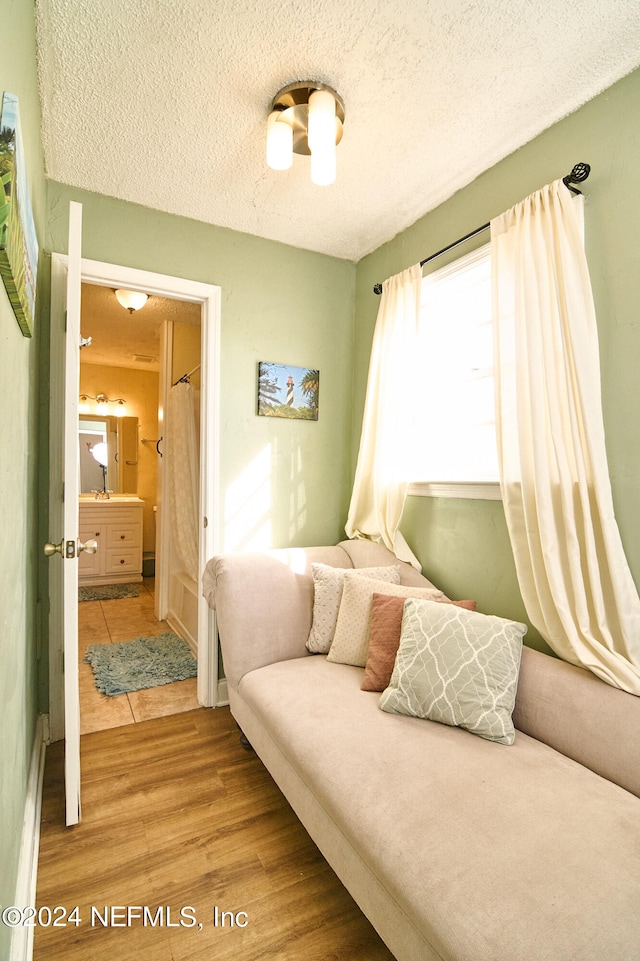 bedroom with hardwood / wood-style flooring and a textured ceiling