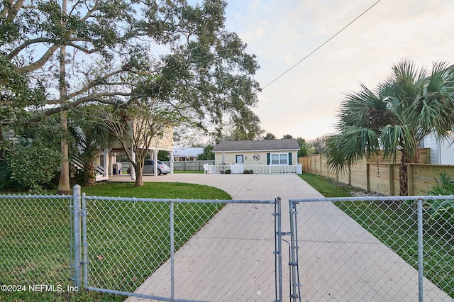 single story home with an outdoor structure and a front lawn