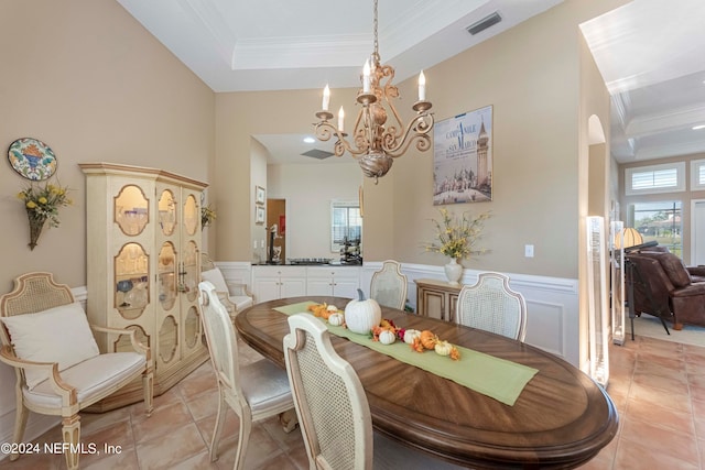 tiled dining area with a chandelier and ornamental molding