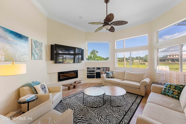 living room featuring ceiling fan, light tile patterned flooring, and ornamental molding