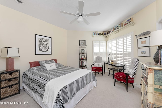 bedroom featuring a ceiling fan and light colored carpet