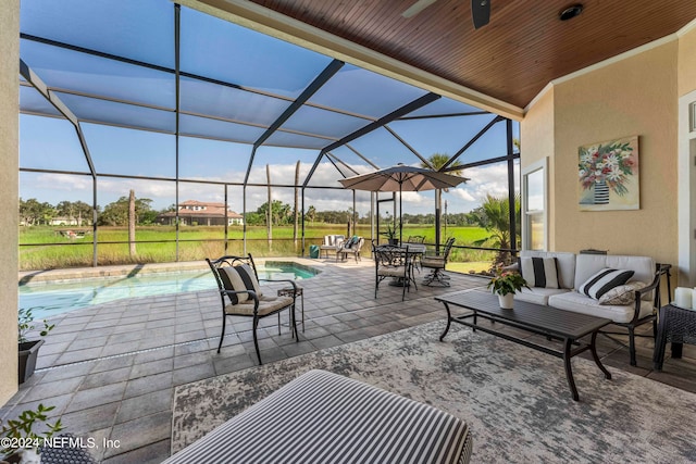 view of patio / terrace with a lanai, outdoor lounge area, and ceiling fan