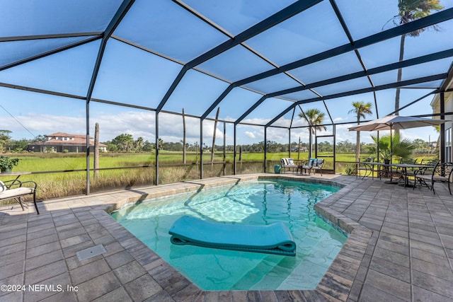 view of pool with a lanai and a patio