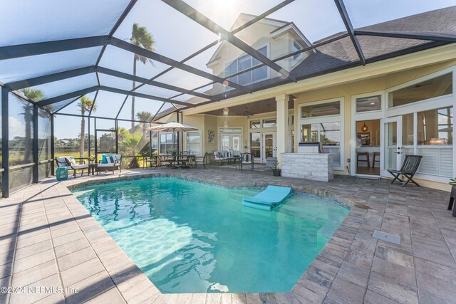 view of swimming pool featuring french doors, a patio, glass enclosure, and ceiling fan