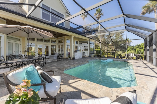 outdoor pool with a patio area, a lanai, and french doors