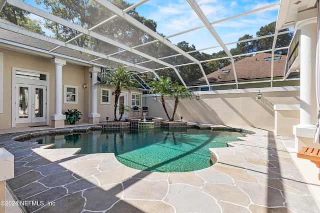 view of pool with french doors, a patio, and a lanai