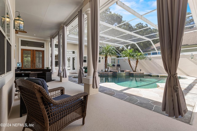 view of pool with a patio area, an in ground hot tub, french doors, and glass enclosure