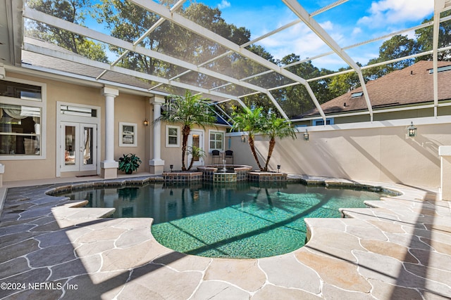 view of pool featuring french doors, a patio, and glass enclosure