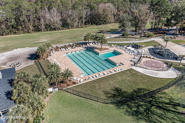 view of swimming pool featuring a yard and a patio area