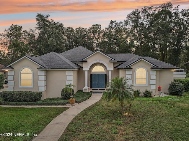 ranch-style house featuring a lawn