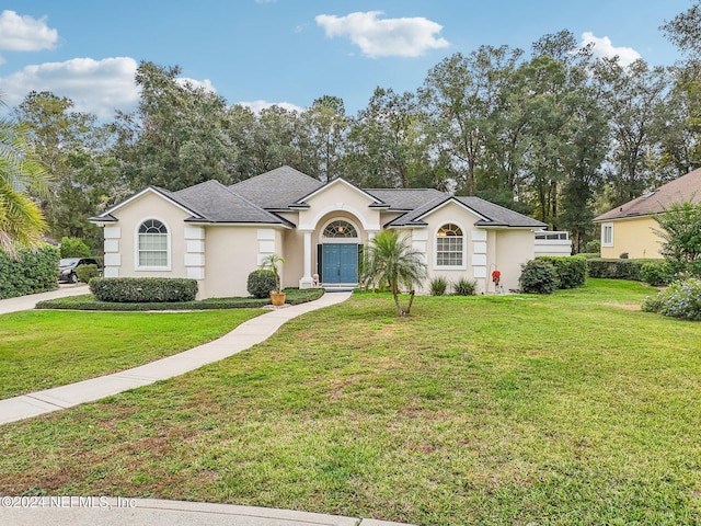 ranch-style house featuring a front yard