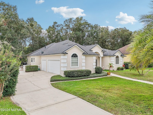 ranch-style house featuring a garage and a front yard