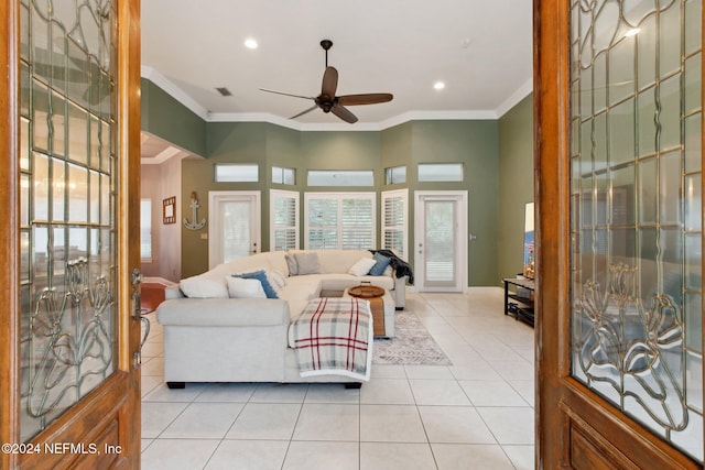 living room featuring light tile patterned floors, ceiling fan, and ornamental molding