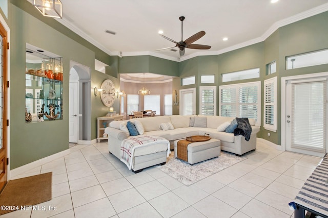 living room with a wealth of natural light, light tile patterned floors, and ornamental molding