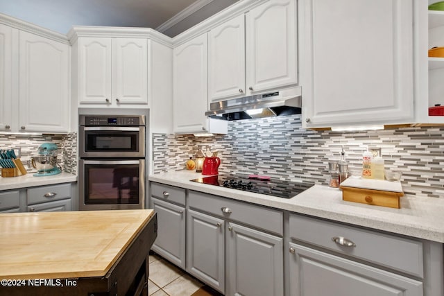 kitchen featuring double oven, black electric cooktop, white cabinets, and gray cabinetry