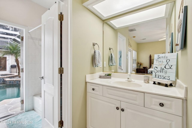 bathroom featuring vanity and tiled shower / bath