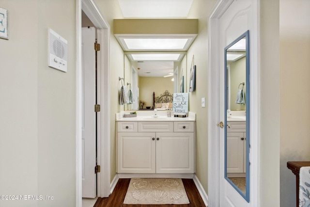 hallway with dark wood-type flooring and sink