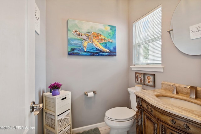 bathroom featuring tile patterned floors, vanity, and toilet