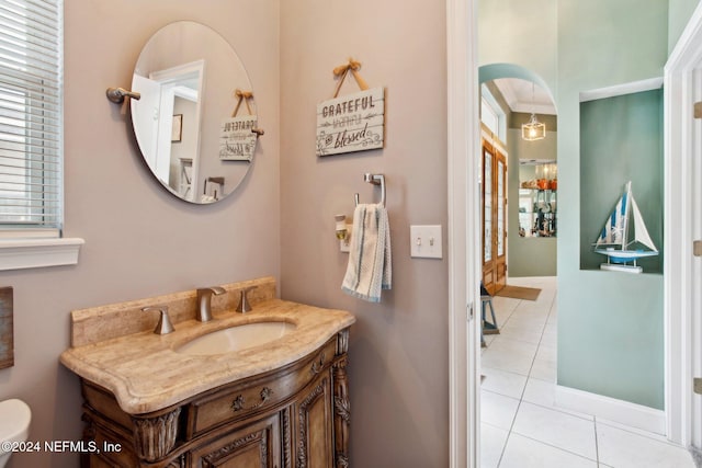 bathroom with tile patterned flooring, vanity, toilet, and crown molding