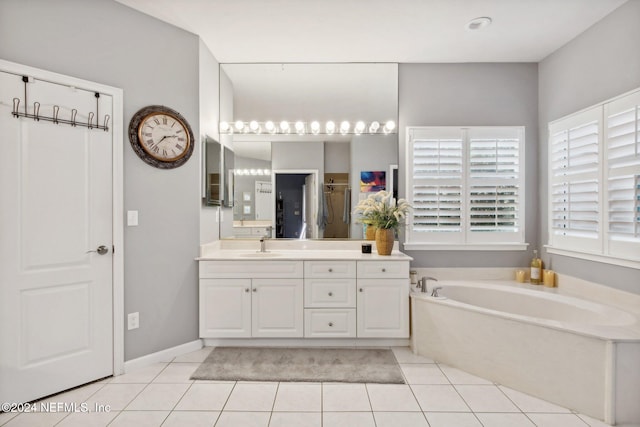 bathroom featuring tile patterned flooring, vanity, and shower with separate bathtub