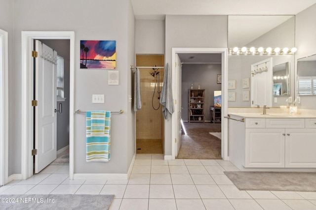 bathroom featuring tile patterned flooring, vanity, and a shower with door