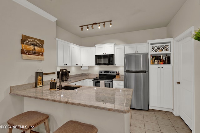 kitchen with kitchen peninsula, white cabinets, stainless steel appliances, and sink