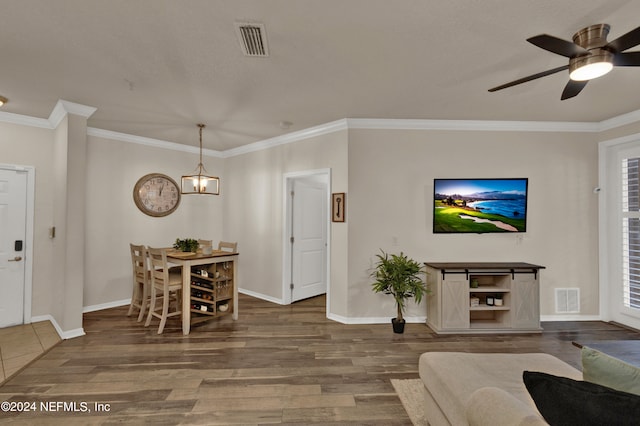 living room with ornamental molding, hardwood / wood-style flooring, and a healthy amount of sunlight