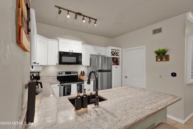 kitchen with kitchen peninsula, sink, light tile patterned flooring, white cabinetry, and appliances with stainless steel finishes