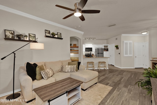 living room featuring ceiling fan, crown molding, and hardwood / wood-style floors