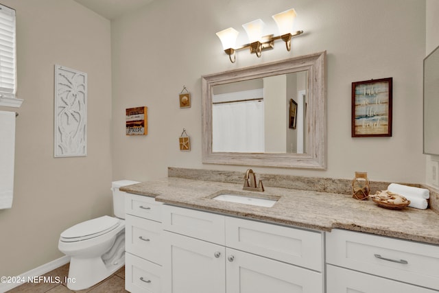 bathroom featuring vanity, toilet, and tile patterned floors