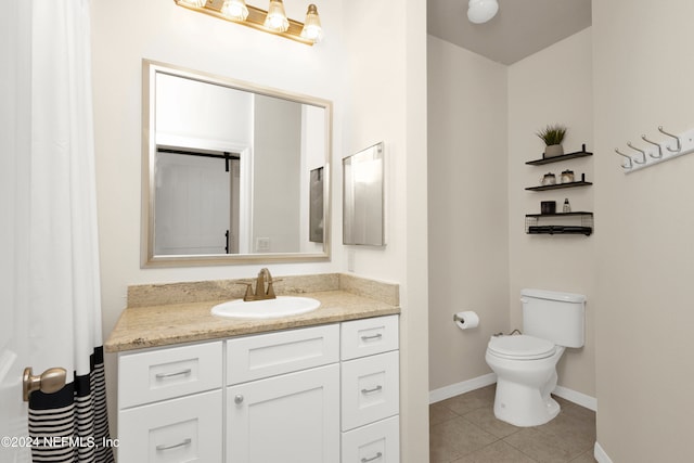 bathroom with vanity, toilet, and tile patterned floors