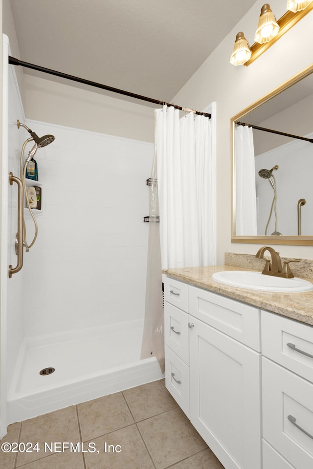 bathroom with vanity, curtained shower, and tile patterned floors