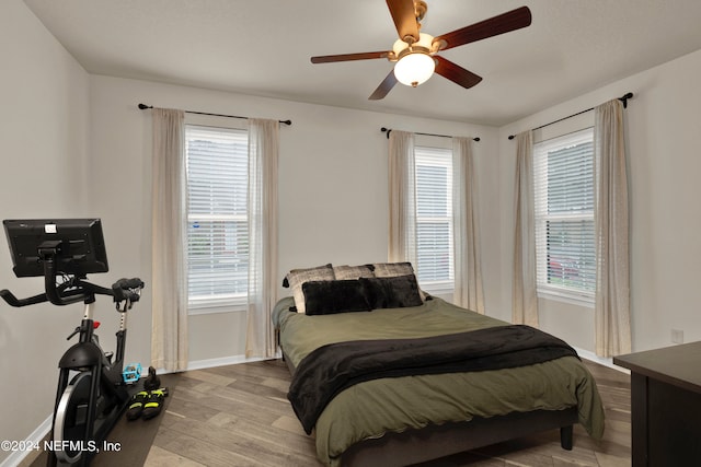 bedroom with light hardwood / wood-style floors and ceiling fan