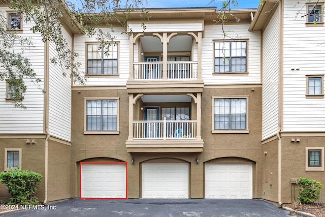 view of front of house featuring a garage and a balcony