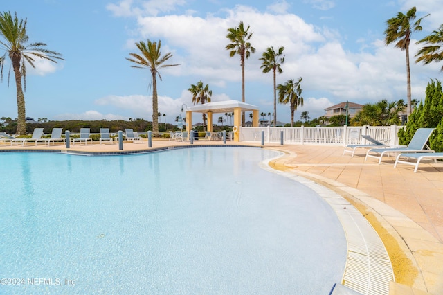 pool featuring a patio area and fence