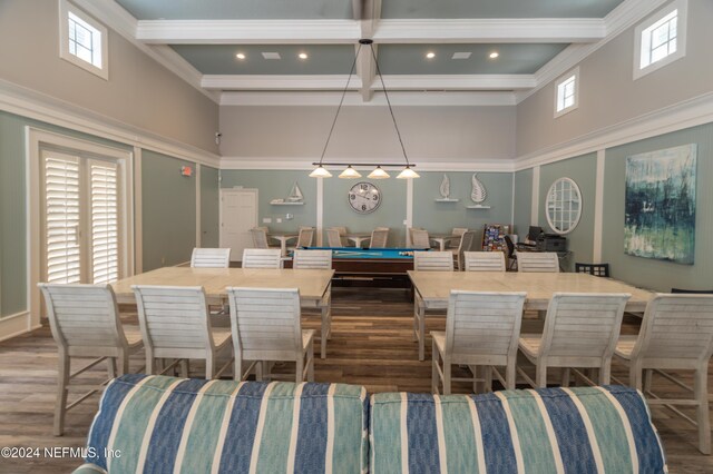 dining space featuring a high ceiling, wood finished floors, and coffered ceiling