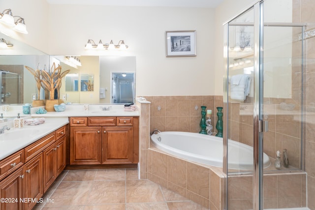 bathroom with double vanity, a shower stall, a sink, and a bath