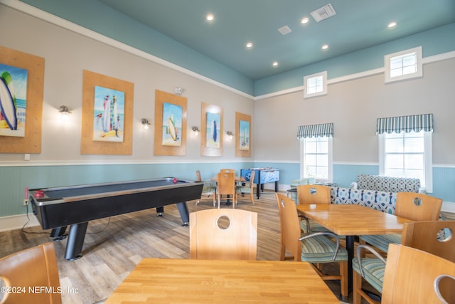 playroom featuring visible vents, wainscoting, wood finished floors, and a healthy amount of sunlight