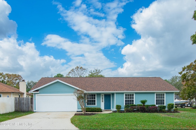 ranch-style house with a front yard and a garage