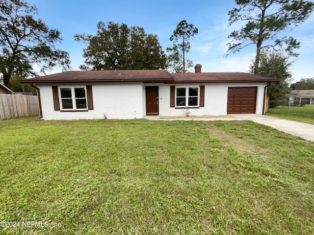 ranch-style house with a front yard and a garage