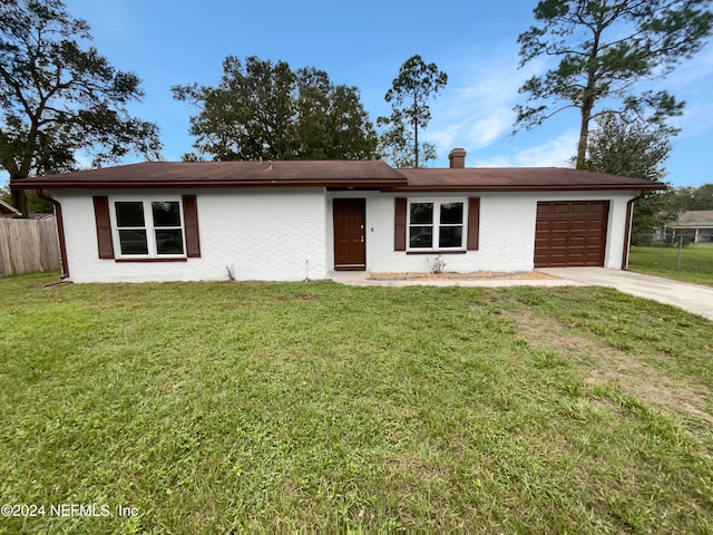 ranch-style home with a front lawn and a garage