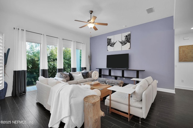 living room featuring ceiling fan and dark hardwood / wood-style floors