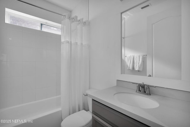 full bathroom featuring shower / bath combo, vanity, and toilet