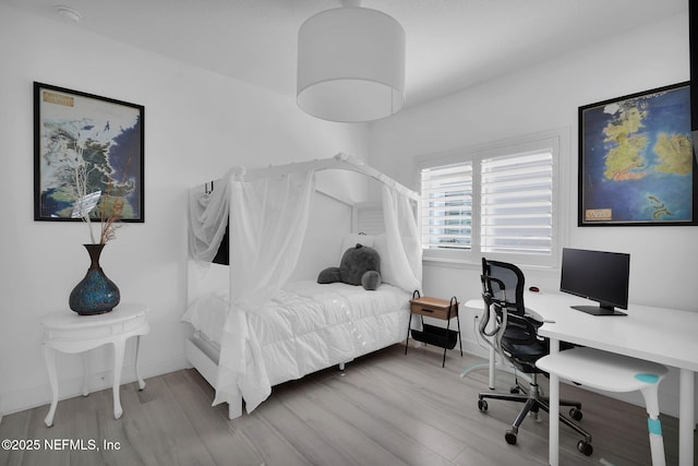 bedroom with hardwood / wood-style floors