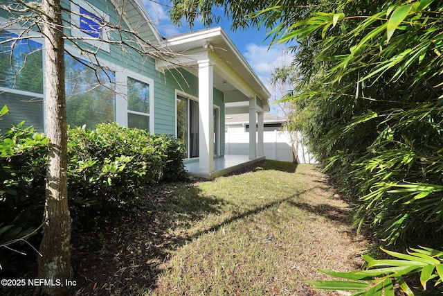 view of side of property with a lawn