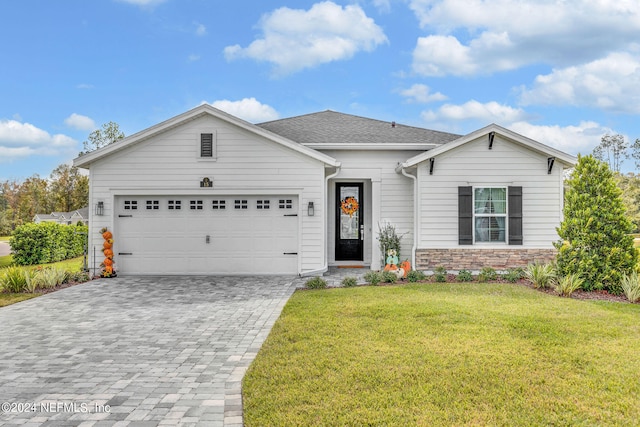 single story home with a garage and a front yard