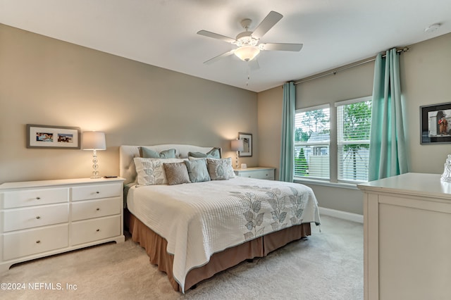 bedroom with light colored carpet and ceiling fan