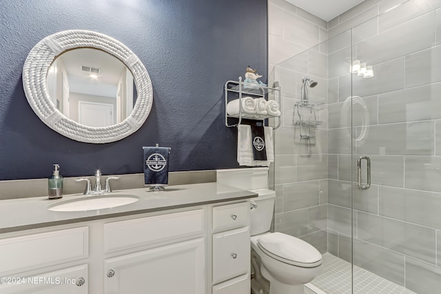 bathroom featuring vanity, toilet, and walk in shower