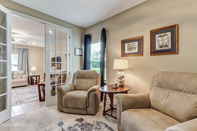 living area with light tile patterned floors and french doors