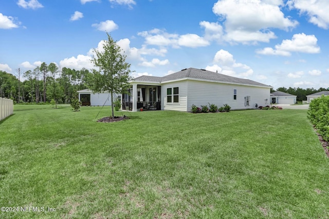 back of property featuring a lawn